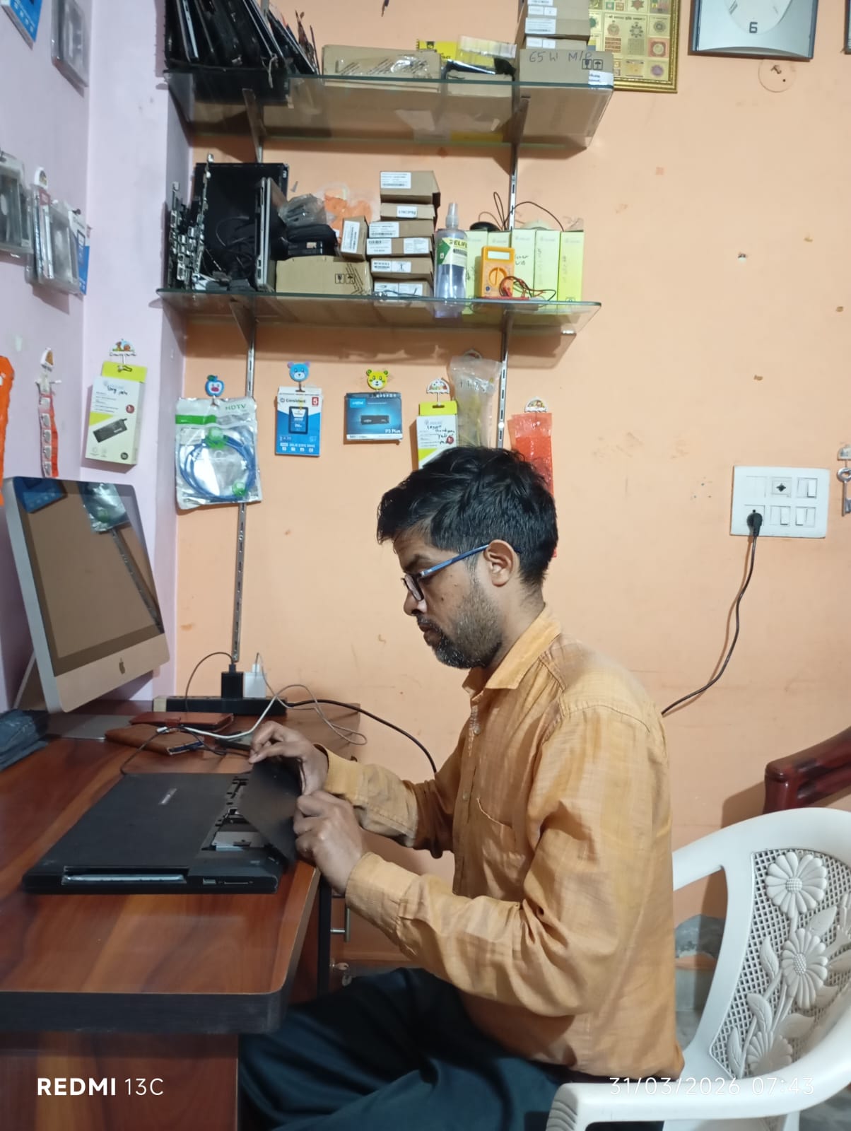 Certified technician performing a laptop repair with precision tools on an open motherboard.